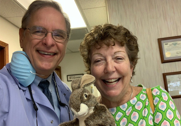 Dr. with a patient and a stuffed bunny.