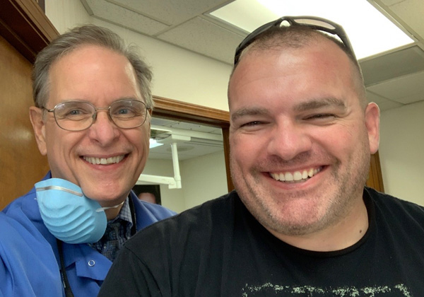 Dr. and a happy patient with a bright smile.